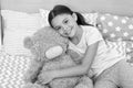 Kids evening routines. Favorite toy. Girl child hug teddy bear in her bedroom. Pleasant time in cozy bedroom. Girl kid Royalty Free Stock Photo