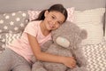 Kids evening routines. Favorite toy. Girl child hug teddy bear in her bedroom. Pleasant time in cozy bedroom. Girl kid Royalty Free Stock Photo