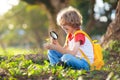 Kids explore nature. Children hike in sunny park