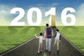 Kids and father walking toward numbers 2016 Royalty Free Stock Photo