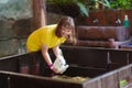 Kids feed animals at petting zoo Royalty Free Stock Photo