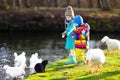 Kids feeding otter in autumn park Royalty Free Stock Photo