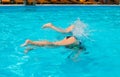 Kids feet in the air in the swimming pool, fun diving Teens Royalty Free Stock Photo