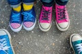 kids feet with mismatched shoes, deciding which to choose