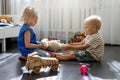 Kids are fighting over a toy. conflict between sister and brother. sibling relationships