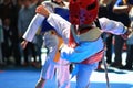 Kids fighting on stage during Taekwondo contest