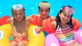 Kids floating in swimming pool Royalty Free Stock Photo