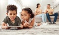 Kids on floor with tablet in living room, watching fun and educational videos or playing game online with parents on Royalty Free Stock Photo