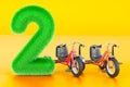 Kids fluffy number 2 with two kids tricycles, 3D rendering