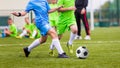 Kids Football Match. Boys Kicking Football Ball on Sports Field Royalty Free Stock Photo