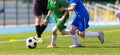 Kids Football Players Kicking Ball on Soccer Field Royalty Free Stock Photo