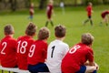 Kids Football Team. Children Football Academy. Substitute Soccer Players Sitting on Bench. Young Boys Royalty Free Stock Photo