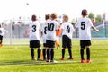 Kids Football Team. Young Boys Watching Soccer Match. Football Tournament Competition in the Background. Royalty Free Stock Photo