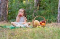 Kids forest picnic. Child with basket of autumn fruits eating apple. Toddler kid in sunny park. Little girl enjoying Royalty Free Stock Photo