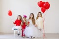 Beautiful kids friends with red balloons in the shape of a heart at the holiday Royalty Free Stock Photo