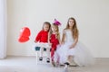 Beautiful kids friends with red balloons in the shape of a heart at the holiday Royalty Free Stock Photo