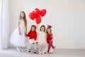 Beautiful kids friends with red balloons in the shape of a heart at the holiday Royalty Free Stock Photo