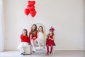 Beautiful kids friends with red balloons in the shape of a heart at the holiday Royalty Free Stock Photo