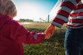 Kids friendship- boy and girl holding hands in the city