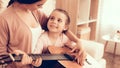 Mom with Guitar in Hand and Girl Sitting on Carpet Royalty Free Stock Photo