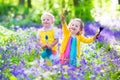 Kids in a garden with bluebell flowers Royalty Free Stock Photo