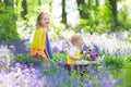 Kids in a garden with bluebell flowers Royalty Free Stock Photo