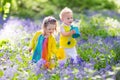 Kids in a garden with bluebell flowers Royalty Free Stock Photo