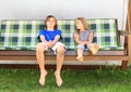 Kids on a garden swing Royalty Free Stock Photo