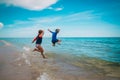 Kids- girl and boy- run and play with waves on beach Royalty Free Stock Photo