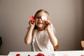 Kids, girl crafting red valetine heart card on table at home