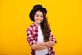 Kids girl in old fashion clothes. Elegent hat, cylinder hat isolated on yellow background. Headwear. Clothes accessories