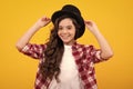 Kids girl in old fashion clothes. Elegent hat, cylinder hat isolated on yellow background. Headwear. Clothes accessories