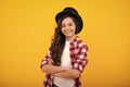 Kids girl in old fashion clothes. Elegent hat, cylinder hat isolated on yellow background. Headwear. Clothes accessories