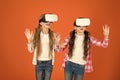 Kids girls play virtual reality game. Friends interact in vr. Explore alternative reality. Future is present. Cyber Royalty Free Stock Photo