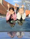 Kids - girls on windscreen of a car