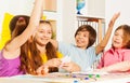 Kids giving hive five sitting at the gaming table Royalty Free Stock Photo