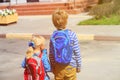 Kids go to school- little boy and girl with backpacks on the street Royalty Free Stock Photo