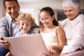 Kids with grandparents. A shot of two kids and their grandparents using a digital tablet while sitting on the sofa. Royalty Free Stock Photo