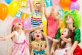 Kids group with clown celebrating birthday party Royalty Free Stock Photo