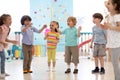 Kids group have fun and play at kindergarden