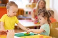 Kids group making arts and crafts in kindergarten. Children on lesson in daycare centre Royalty Free Stock Photo