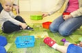 Kids group making arts and crafts in kindergarten. Children spending time in day care centre with the great interest