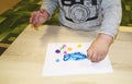 Kids group making arts and crafts in kindergarten. Children spending time in day care centre with the great interest
