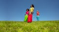 Kids gunny race in bags downhill on the lawn grass Royalty Free Stock Photo