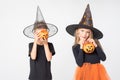 Kids Halloween. A beautiful cute girl in a witch costume and a boy holding baskets in the shape of Jack's lantern. Royalty Free Stock Photo