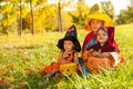 Kids in Halloween costumes sitting on the grass Royalty Free Stock Photo