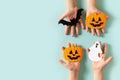 Kids halloween handmade paper pumpkins with childrens hands