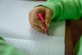 Kids hand drawing or wrinting in a notebook Royalty Free Stock Photo