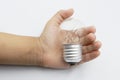 Kids hand holding a light bulb isolated on white background