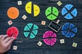 Kids hand moves colorful math fractions on dark wooden background or table. Interesting creative funny math for kids. Education